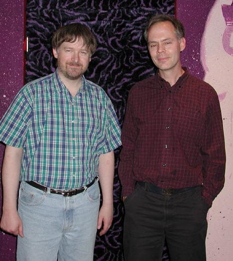Two men standing indoors; one of them is Jim Horne, the Microsoft programmer who popularized FreeCell by bringing it to Windows.